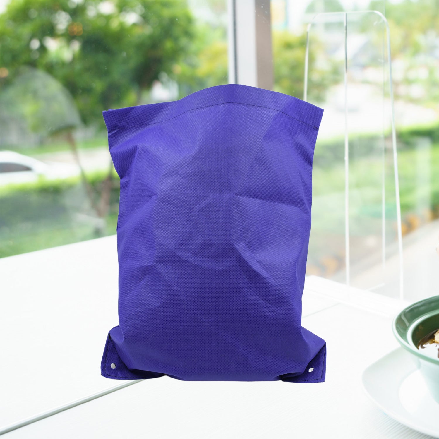 Reusable grocery bag in a neutral colour, folded for compact storage.