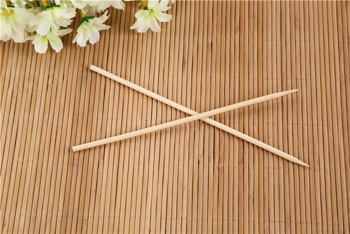 Bundle of natural bamboo skewers tied with string for display.