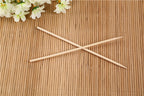 Bundle of natural bamboo skewers tied with string for display.