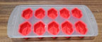 Assorted colorful silicone ice cube moulds featuring various fruit designs for creative desserts.