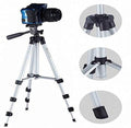 A Gambit camera tripod with a phone holder extended, ready for capturing photos.