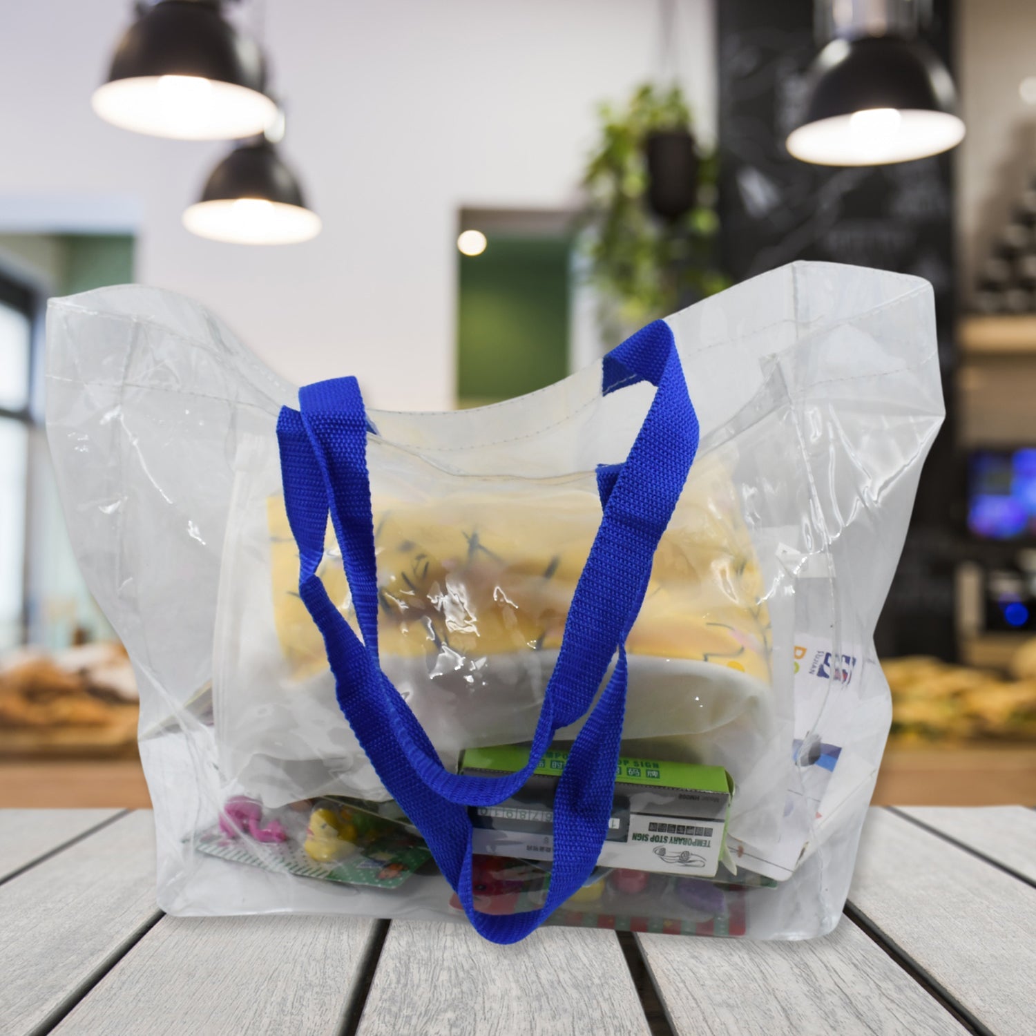 Transparent carry bag with ample space for shopping items.
