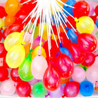 Kids having fun throwing quick-fill Holi water balloons during celebrations.
