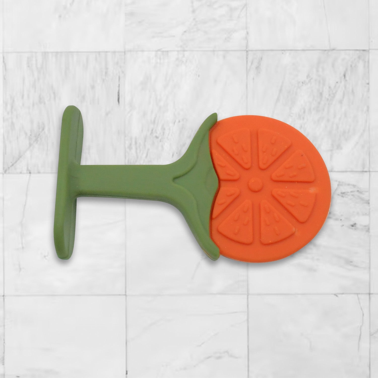Baby's hand grasping a silicone fruit teether toy, showing ergonomic design.