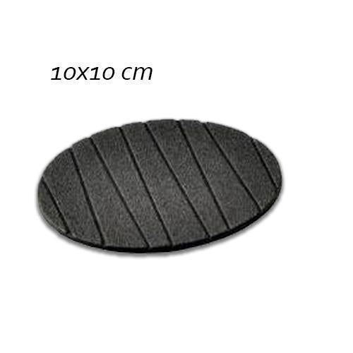 A plain round silicone coaster with a mug of hot coffee, preventing heat damage.