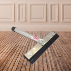The stainless steel kitchen wiper resting on a tiled surface, demonstrating its compact size.