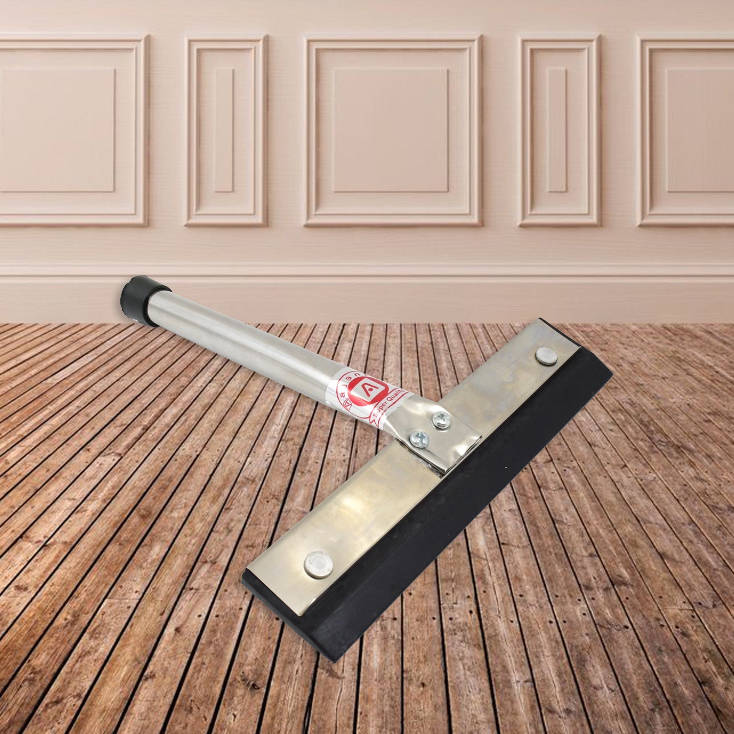 The stainless steel kitchen wiper resting on a tiled surface, demonstrating its compact size.