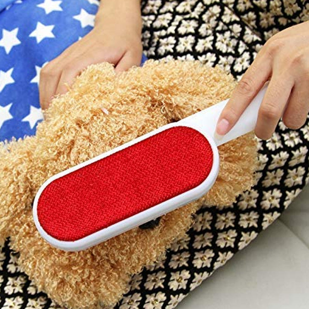 Double-sided pet hair remover brush with self-cleaning base for efficient fur removal.