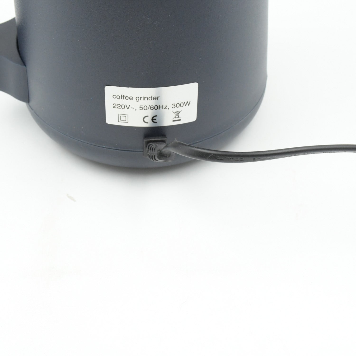 All components of the electric grinder: transparent lid, grinding chamber, and sturdy base.