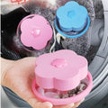Floating washing machine lint catcher with a pink flower detail.