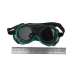 Dark green welding goggles with the outer colored lens flipped up for grinding or inspection.