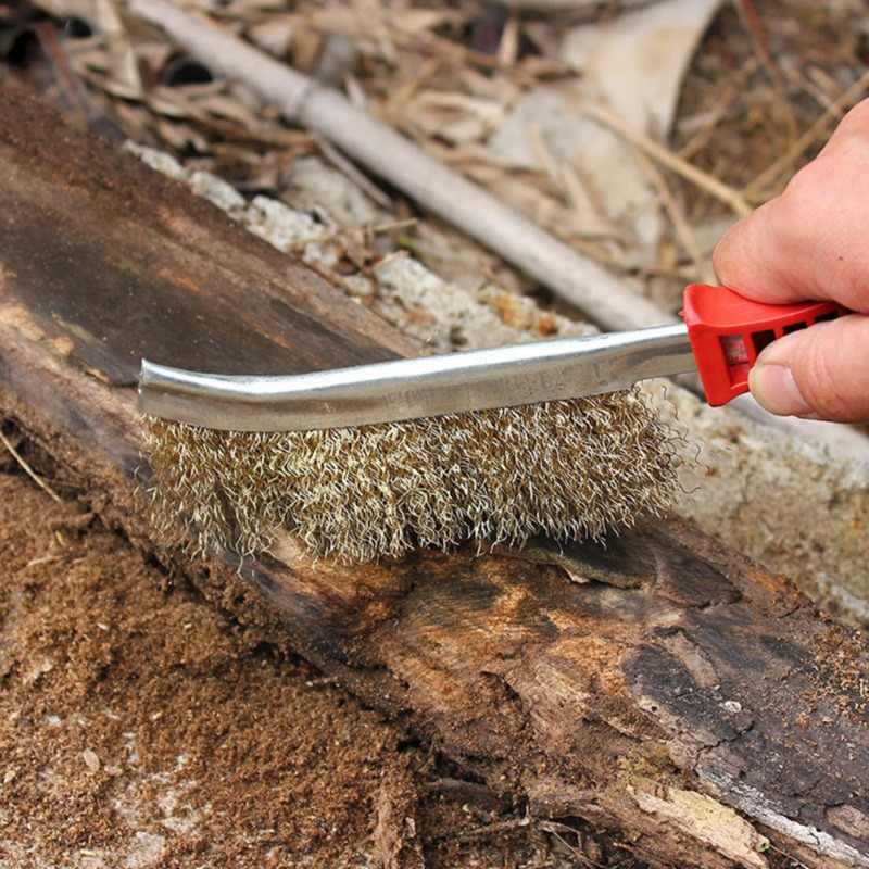 Wire brush for metal cleaning, demonstrating its tough bristle action.