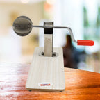 The sleek, shiny stainless steel components of the Quickslice coconut scraper.