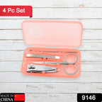 Four stainless steel tools from the manicure set arranged neatly on a surface.