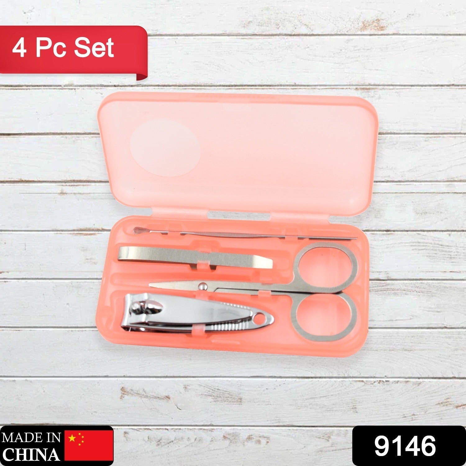 Four stainless steel tools from the manicure set arranged neatly on a surface.