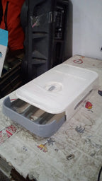 The egg storage box neatly placed inside a refrigerator, optimizing space with its stackable design.