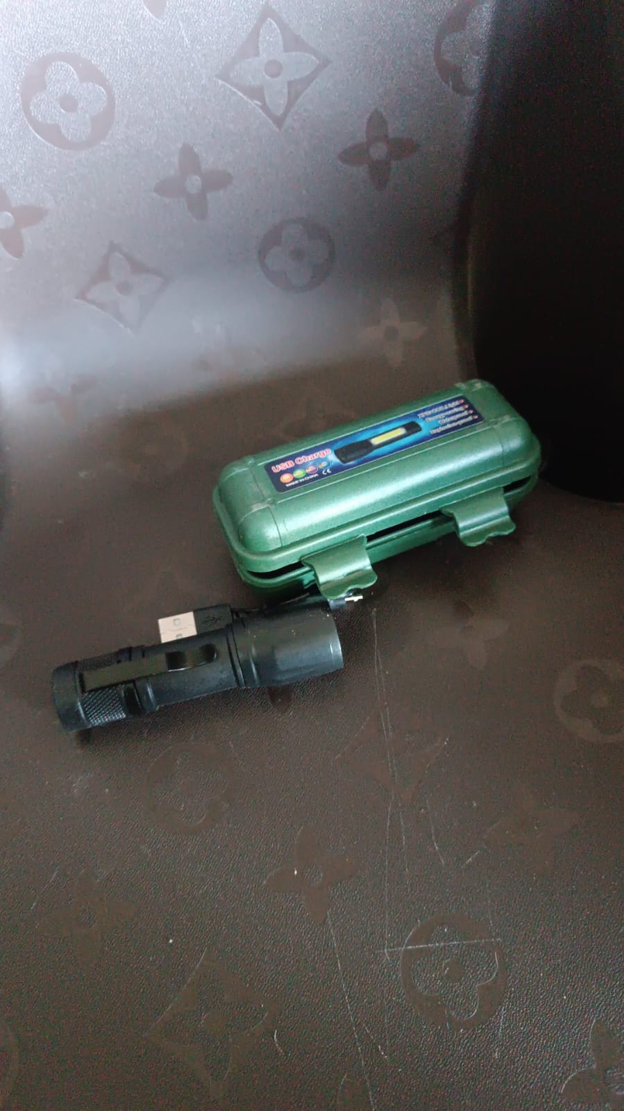 Side view of the versatile rechargeable mini flashlight with metallic finish.