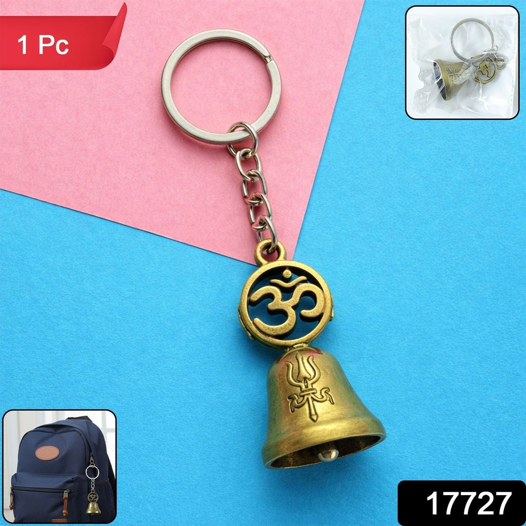 Om temple bell keychain attached to car keys showing its use