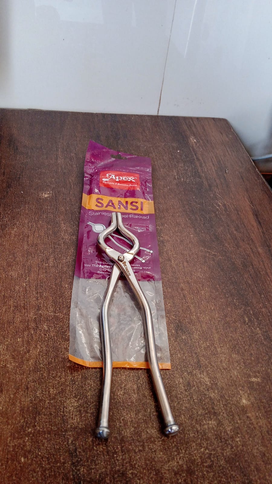 Heavy-duty full round stainless steel pakkad tong in kitchen setting