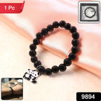 Black beaded stretch bracelet with panda charm placed inside a gift box.