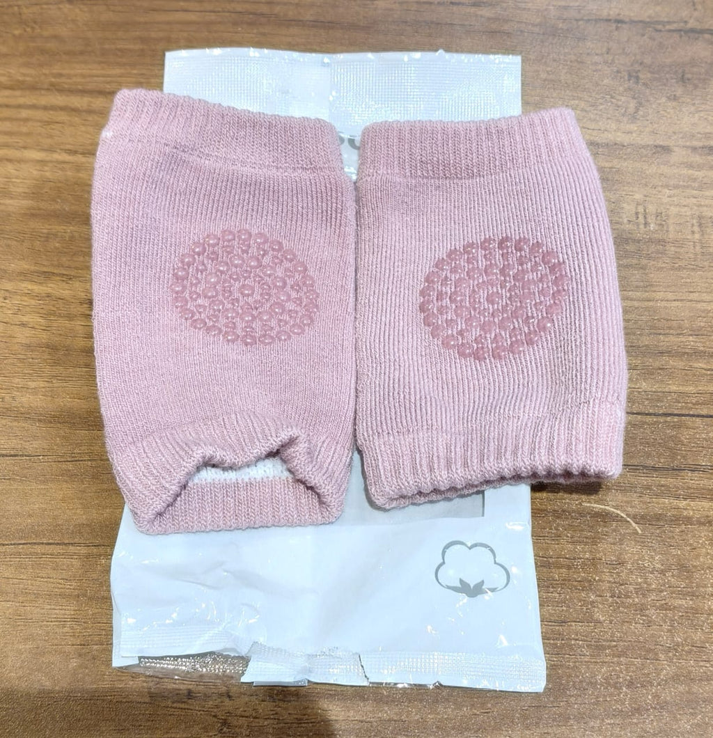 Close-up of knitted pink wool toddler knee warmers with protection