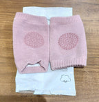 Close-up of knitted pink wool toddler knee warmers with protection