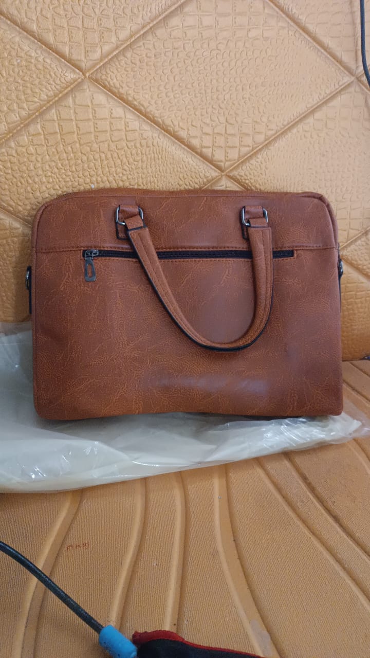Side view of tan faux leather laptop messenger bag with shoulder strap