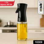 Transparent glass oil mister on a kitchen counter, ready for use.