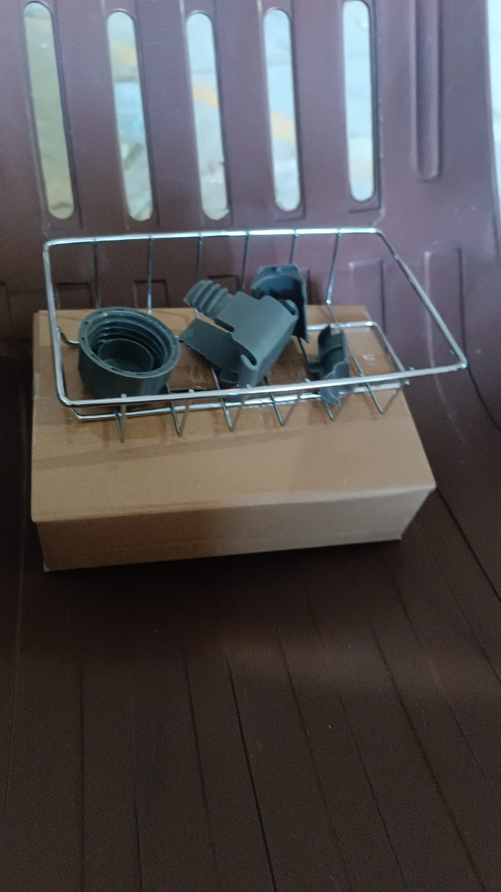 Vertical angle of soap and sponge held by stainless steel sink caddy