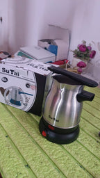 Lifestyle shot of a modern kitchen, suggesting the versatility of the Electric Coffee Maker.