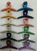 Packaging of Calm & Curl hair claw clips highlighting strong hold features
