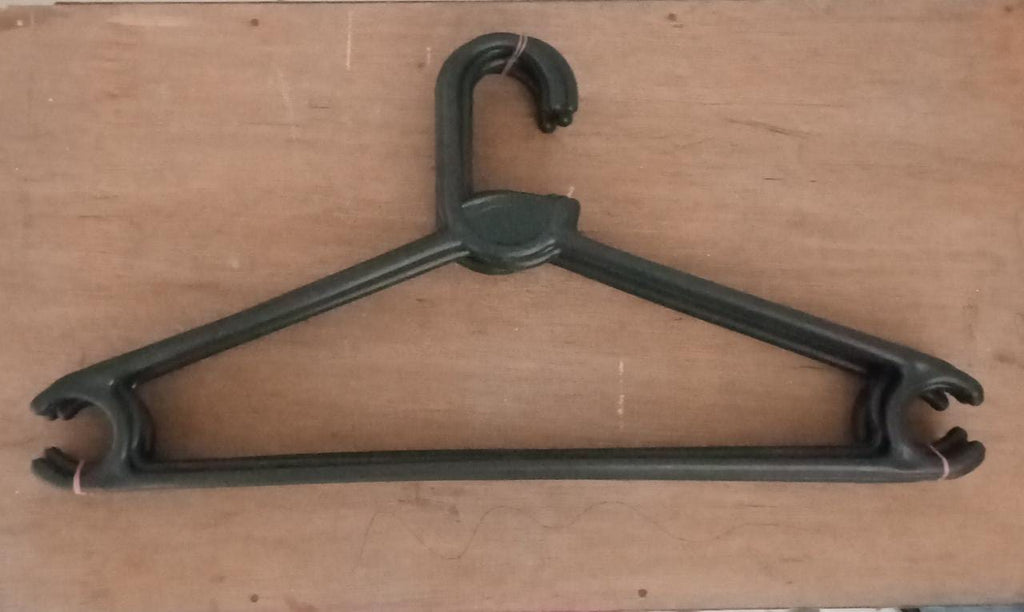 Empty plastic clothes hanger against a plain background, ready for use.