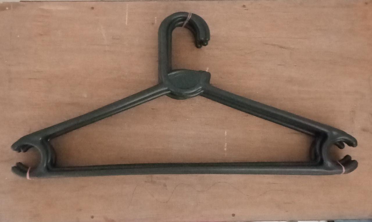 Empty plastic clothes hanger against a plain background, ready for use.