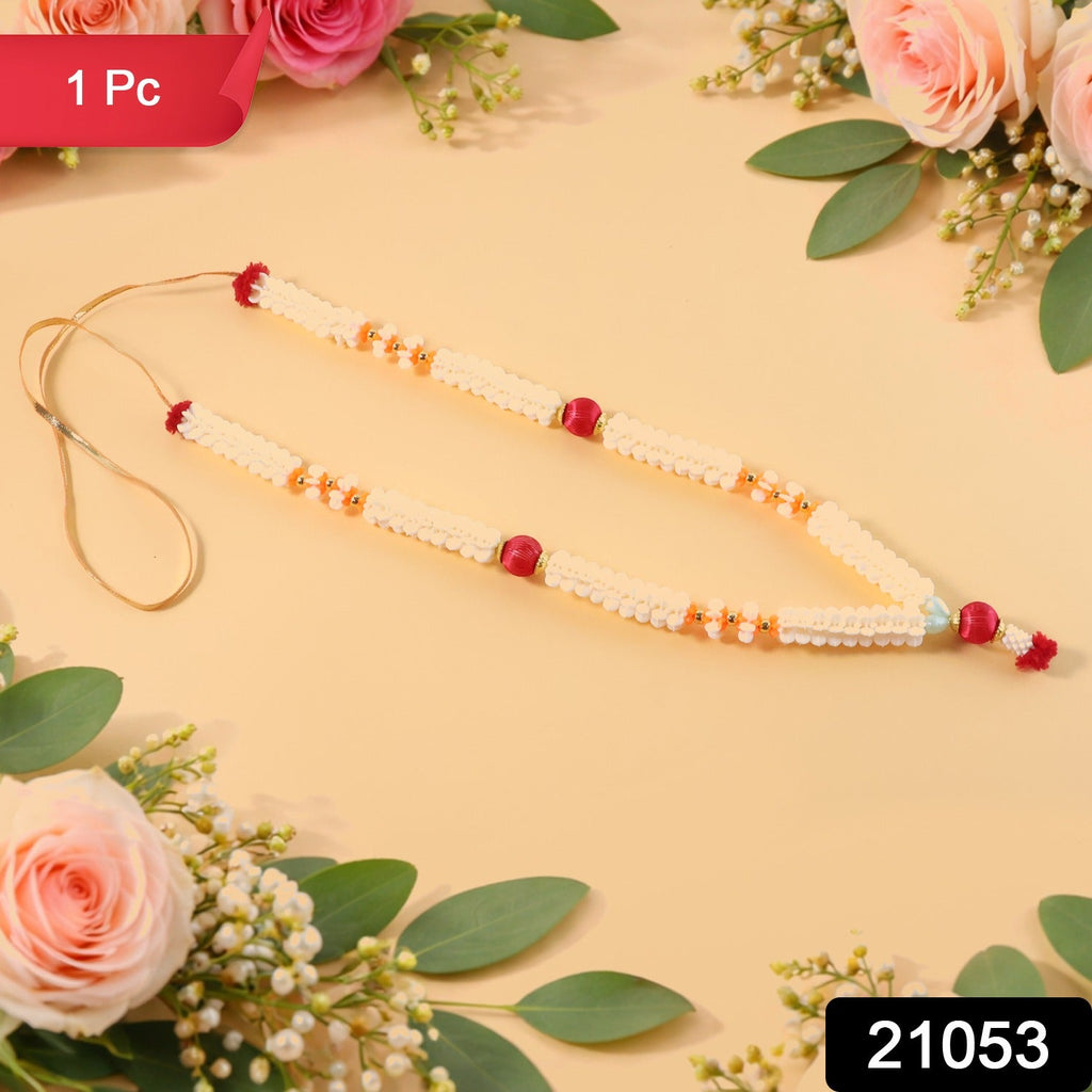 Close-up of decorative pooja flower gajra garland with bead accents