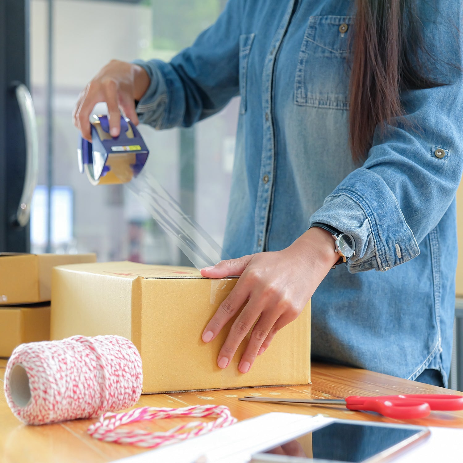 Multiple rolls of transparent high adhesive packing tape ready for use.