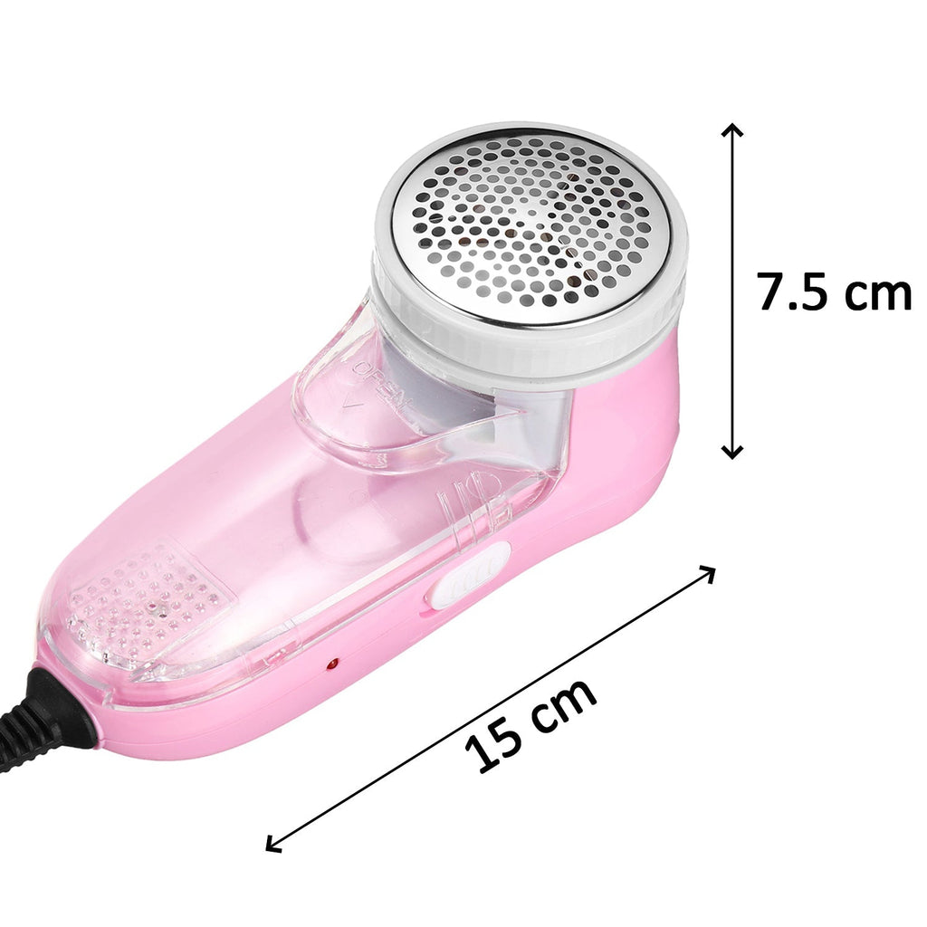 Hand holding the lint remover, demonstrating its use on a soft blanket.