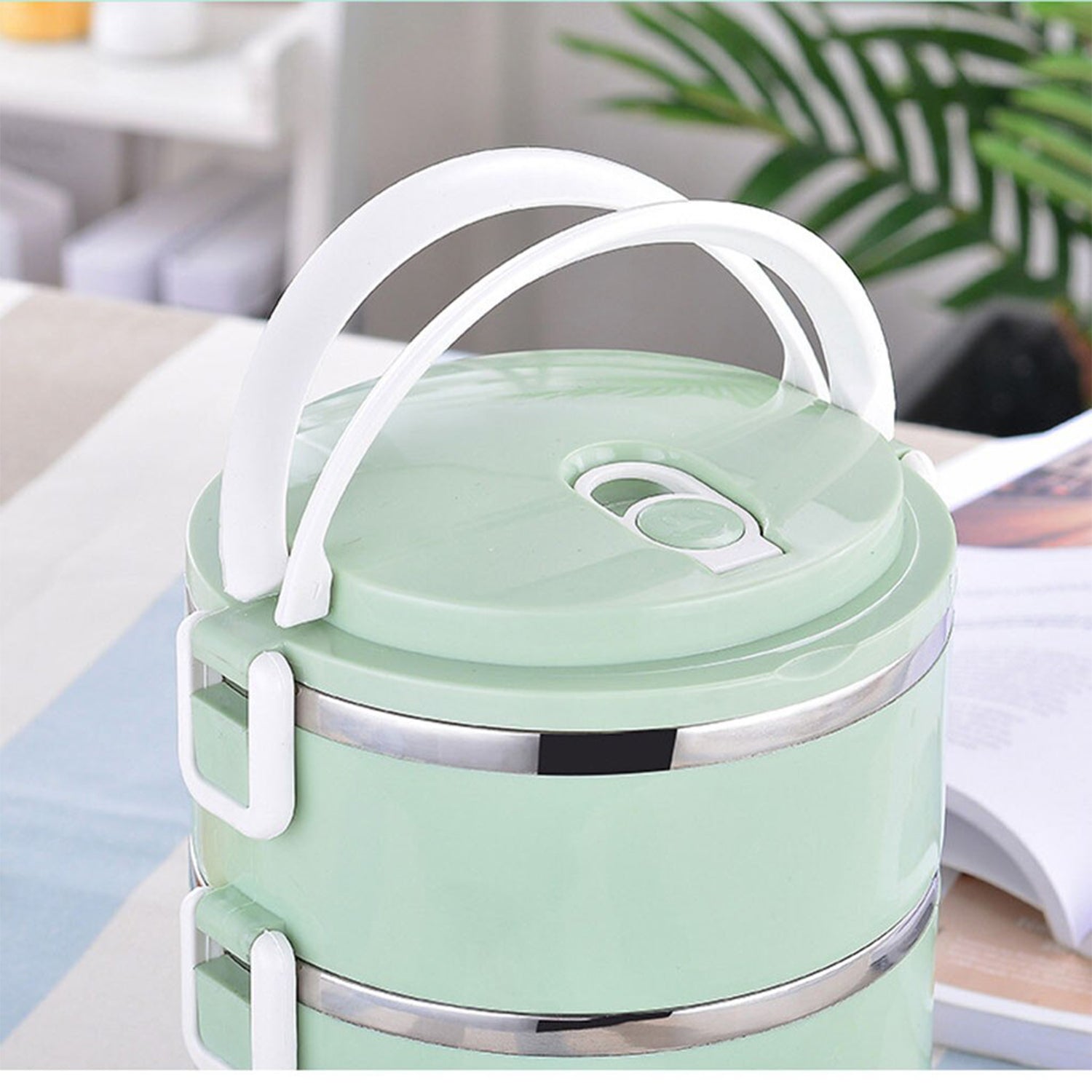 Four separate compartments in a stainless steel hot food tiffin.