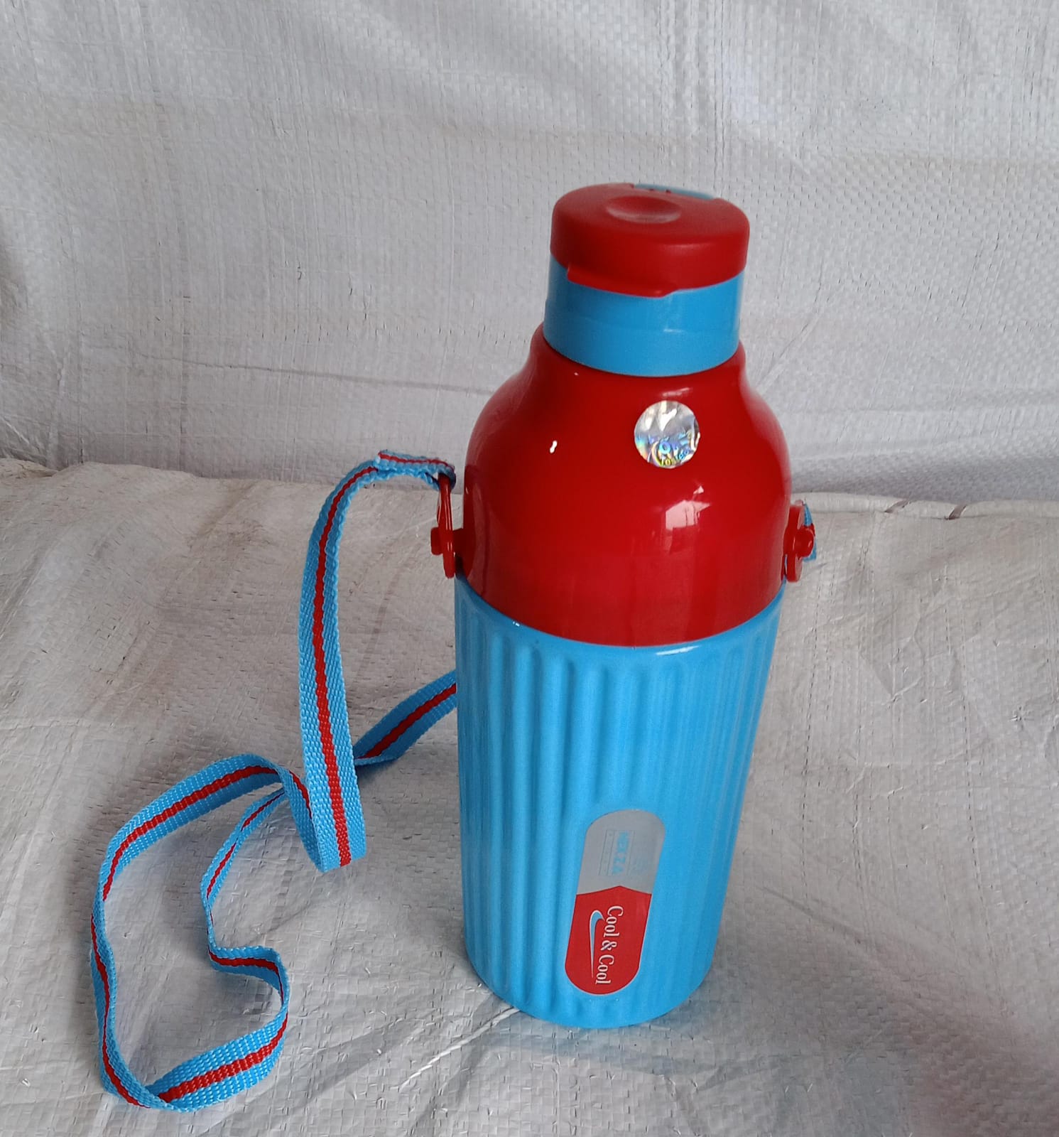 Nekza 500ml insulated water bottle in a vibrant color with its convenient dori strap.