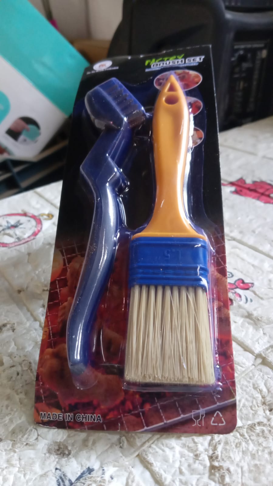 Two basting brushes displayed in a modern kitchen setting.