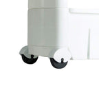 The slim storage rack positioned next to a kitchen appliance, showcasing its discreet fit.