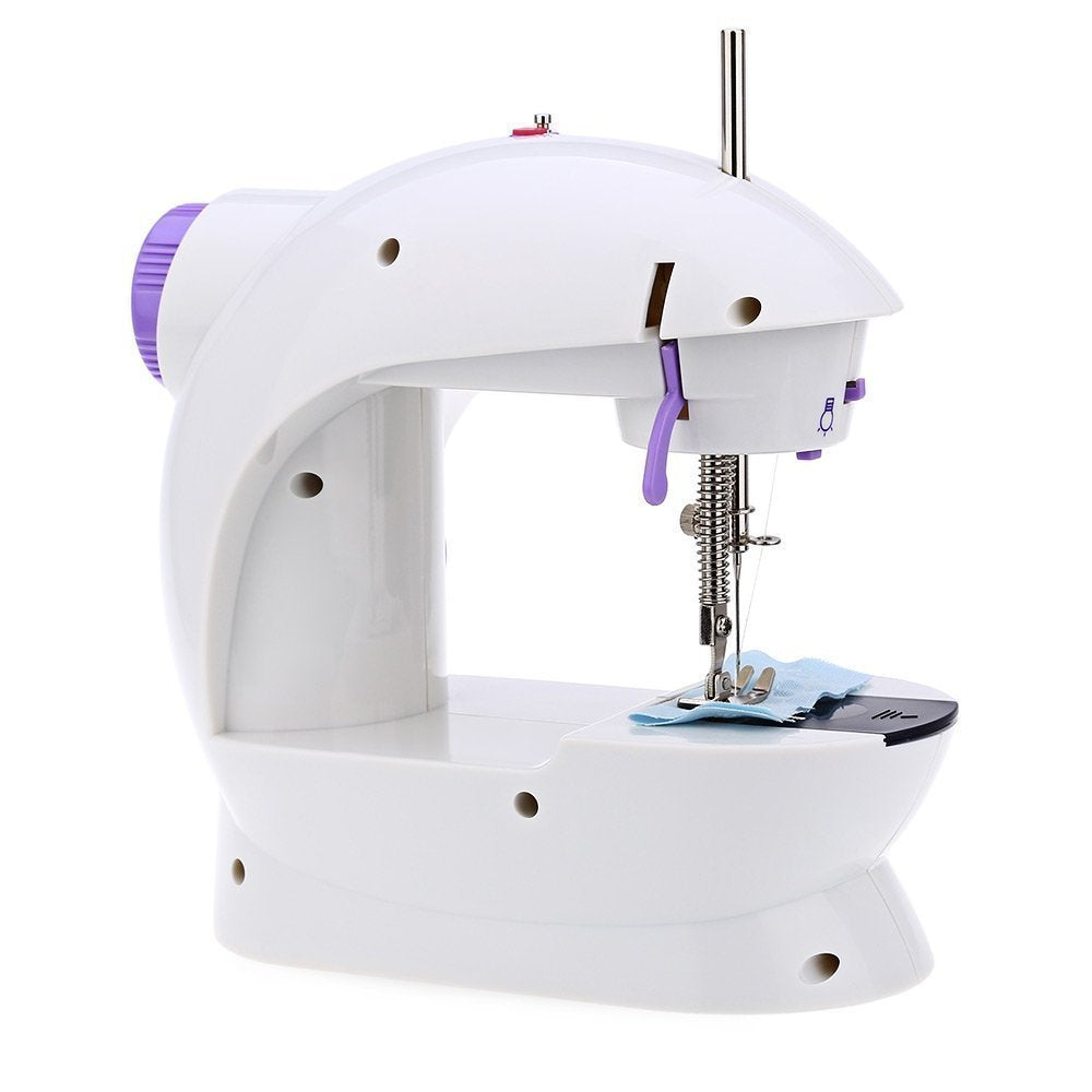 Close-up of the mini sewing machine's needle and thread for fabric stitching.