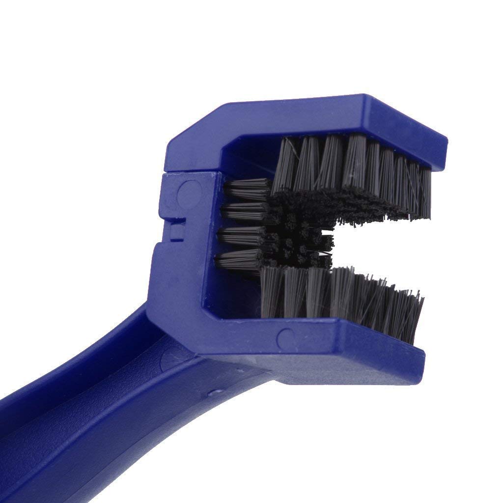Motorbike chain cleaner tool actively used on a dirty bike chain for demonstration.