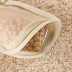 Stack of transparent 150ml food storage zipper bags for kitchen organisation.