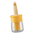 A side view of the transparent oil dispenser bottle, emphasizing its sleek kitchen design.