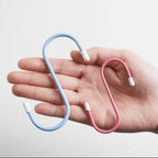 Multiple S hooks on a standard rod, demonstrating their easy application for various items.
