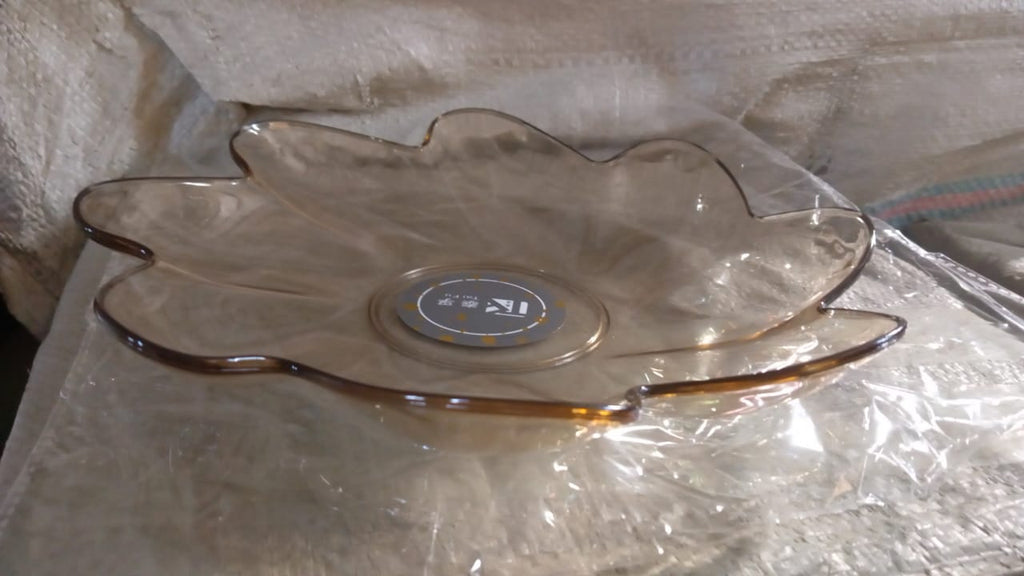 A side view of a flower shaped kids plastic plate, showing its shallow depth suitable for snacks and small meals.