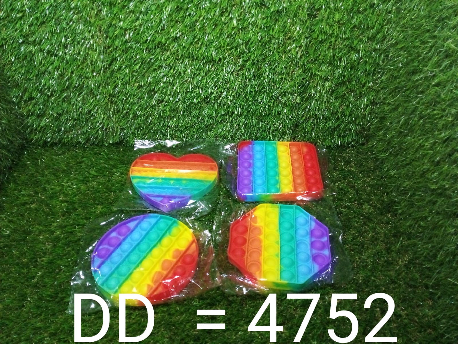 Rainbow colored fidget toy held in hand showing bubble detail