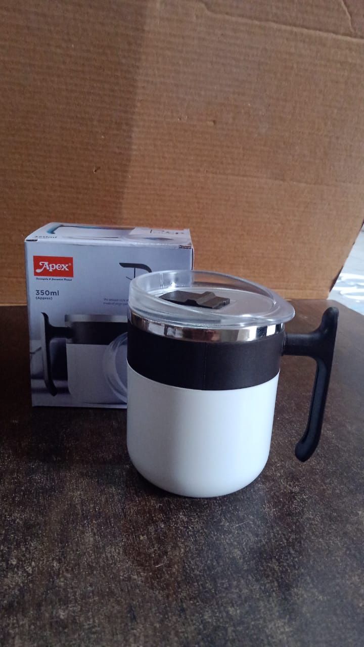 Close-up side view of the white insulated mug on a flat surface.