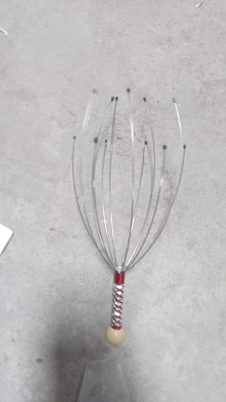The compact handheld scalp massager, ideal for gifting for health and wellness.