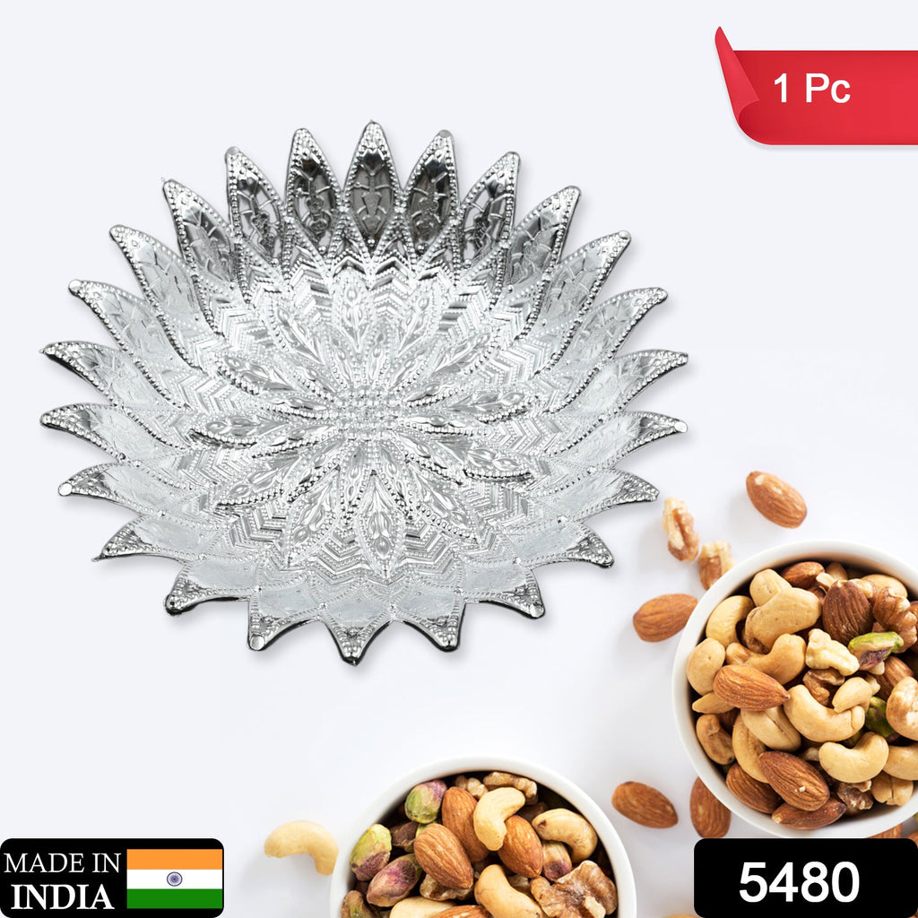 Close-up of a traditional silver finish plastic serving tray with intricate design.